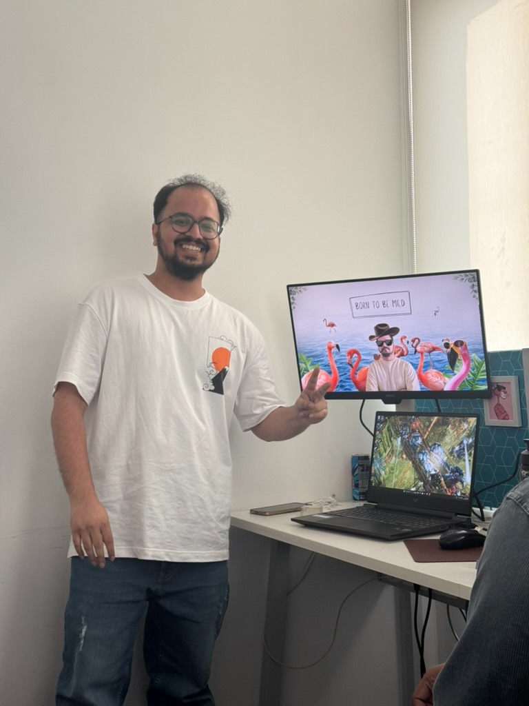 Team member with creative work on screen